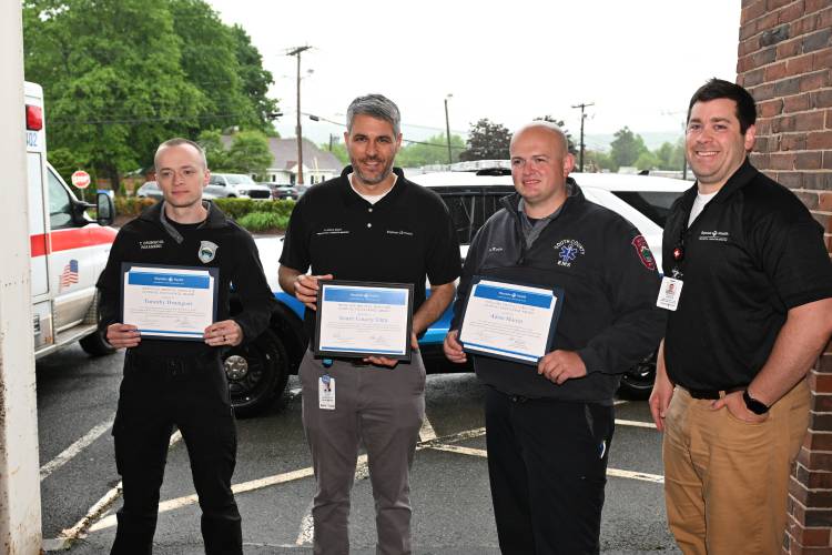 South County EMS paramedic Tim Drumgool, Baystate Health physician and Associate Regional EMS Medical Director Dr. Matthew Shapiro, South County EMS paramedic Adam Martin and Baystate EMS Coordinator Nicholas Chirekos in an awards ceremony at Baystate Franklin Medical Center on Thursday.