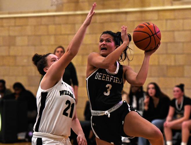 Deerfield Academy’s Charli Firestone (3), right, drives to the basket while defended by Williston’s Kat Mayer (21) during NEPSAC action in Deerfield on Wednesday.
