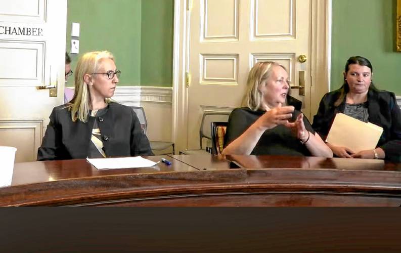 Alexandra Flanders, at left, watches as retired Judge Beth Crawford testifies in favor of her appointment to be an associate justice of Probate and Family Court during a hearing of the Governor’s Council on June 26.