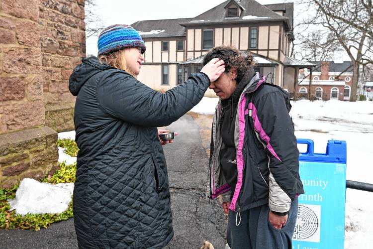 The Rev. Heather Blais of the Episcopal Church of Saints James and Andrew at the corner of Church and Federal streets in Greenfield provides “ashes to go” in front of the church to Greenfield resident Jessica Sanders for Ash Wednesday. The Rev. Heather Blais of the Episcopal Church of Saints James and Andrew at the corner of Church and Federal streets in Greenfield provides “ashes to go” in front of the church to Greenfield resident Jessica Sanders for Ash Wednesday.