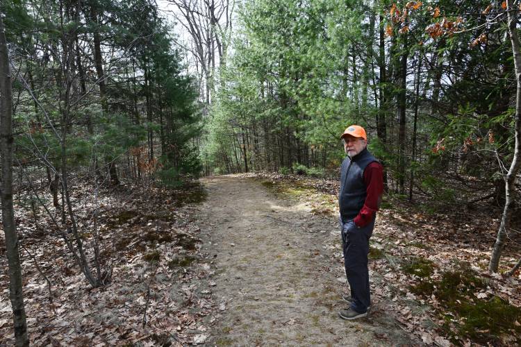 Jack Lochhead walks the established trails on his 65 acres of land bordering Reeds Bridge Road and the South River in Conway. The land is being conserved with help from the Franklin Land Trust.