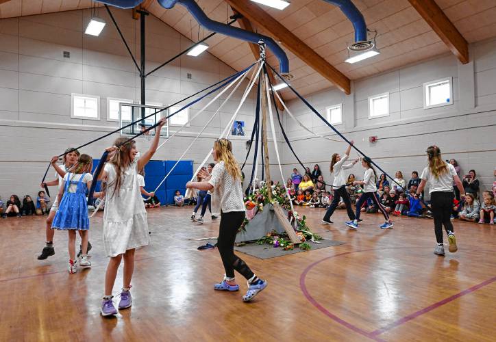 Conway Grammar School students dance around the maypole in the school gymnasium in celebration of May Day on Wednesday.