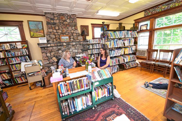 Robertson Memorial Library Director Karin Parks talks with Leyden resident Abbi Pratt in the Leyden library on Monday.
