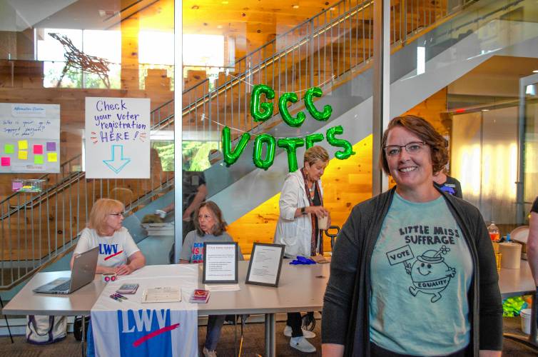 Greenfield Community College President Michelle Schutt in front of the voter registration table on Tuesday.