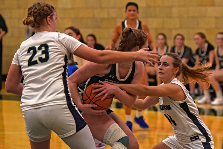 Williston’s Meg Carey (14), right, and Skyler Walker (23) surround Deerfield Academy’s Charlotte Coodduring NEPSAC action in Deerfield on Wednesday.