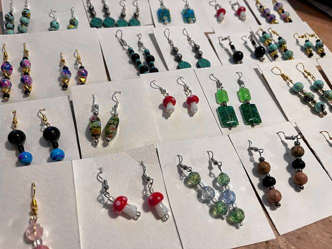 Elaina Holloway, a 6-year-old who runs Peaches Boutique, makes earrings that will be for sale.