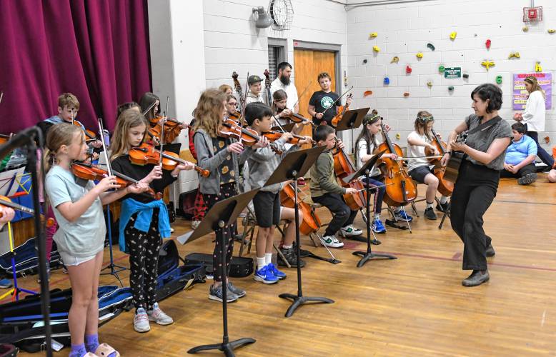 Students in the Conway Grammar School string band play their instruments during a celebration of May Day on Wednesday.