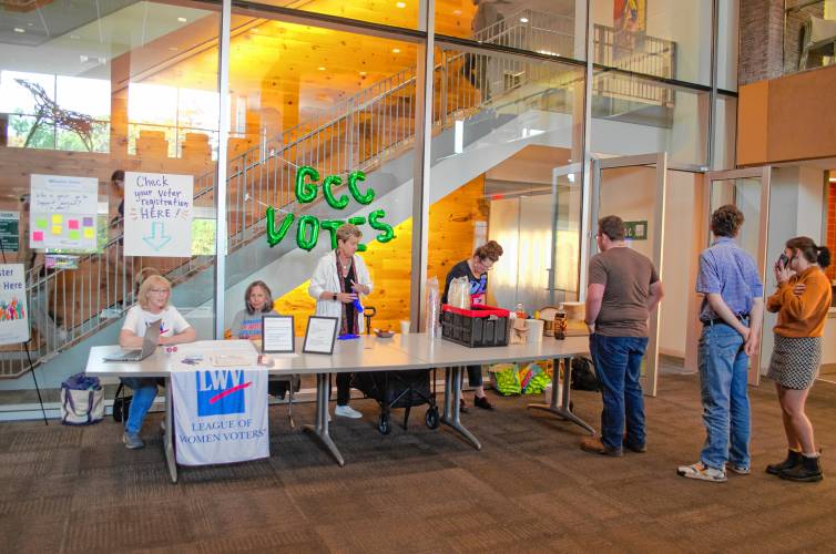 Greenfield Community College students line up for free ice cream floats for National Voter Registration Day served by Student Activities Coordinator Sara Allred. Meanwhile, League of Women Voters members Jean Cherdack and Ruth Odom offer assistance and answer questions regarding voter registration.