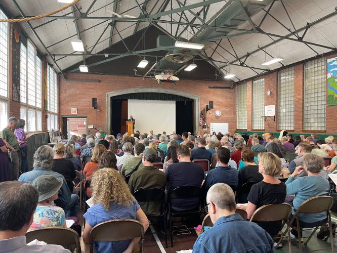 Residents pack the Leverett Elementary School gymnasium on Saturday for Annual Town Meeting.