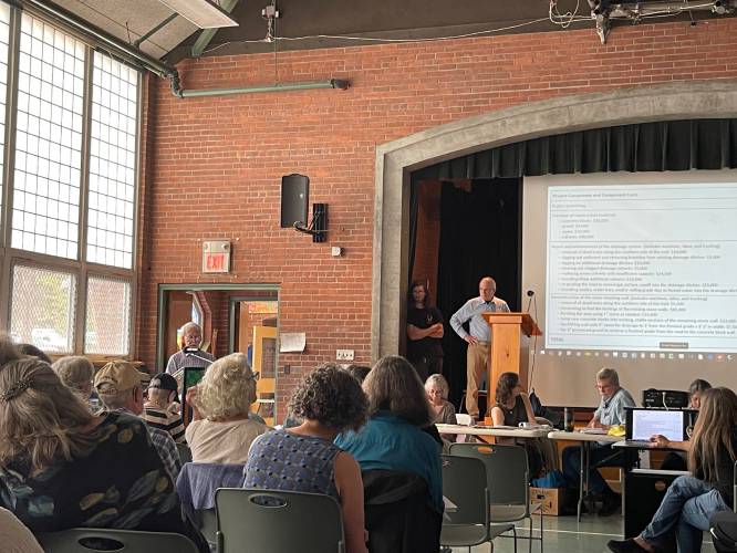 Stephen Weiss explains the state of Rattlesnake Gutter Road in Leverett, calling for repairs, during Annual Town Meeting on Saturday at Leverett Elementary School.