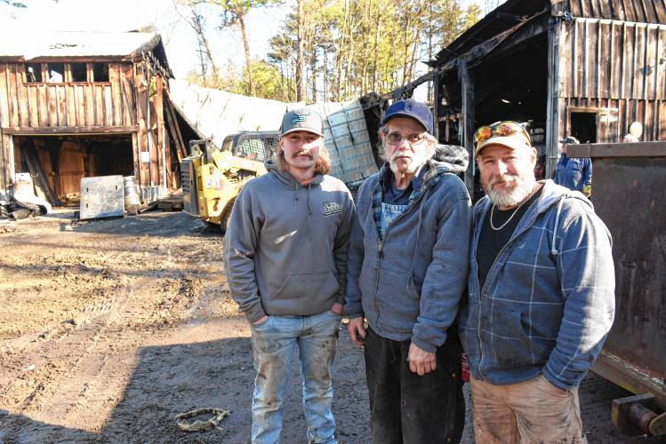 From left, Dylan Saladino of Jacksonville, Vermont, owner Paul Siano Sr. and his son Paul Siano Jr. stand in front of the elder Siano’s commercial garage at 130 Laurel St. in Greenfield that caught fire earlier in this month.