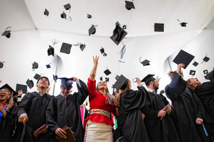 Northfield Mount Hermon 2024 graduates toss their mortorboards at Sunday’s graduation ceremony. 