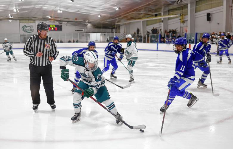 Greenfield’s Matt Garvin (14) handles the puck defended by West Springfield’s Jacob Melvin (11) in the second period Wednesday at Collins-Moylan Arena in Greenfield.