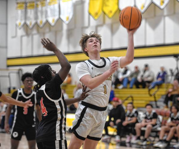 Pioneer's Ben Werner goes up for a layup while guarded by Libertas Academy's Nycolei Nembhard during a quarterfinal contest of the Western Mass. Class D Tournament at Messer Gymnasium Monday. 