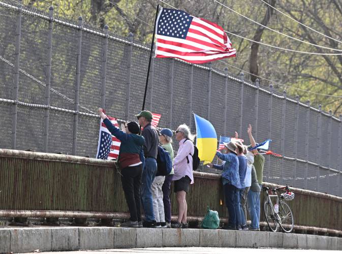Residents participate in a standout against the Trump administration on the Mountain Road Bridge over Interstate 91 in Hatfield, just south of the Whately town line, on Tuesday afternoon.