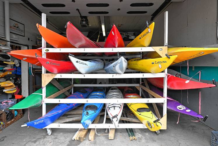 Kayaks wait for water on a rack at Adventure East in Sunderland on Monday morning.