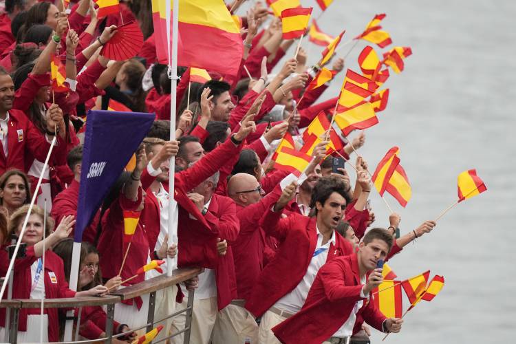 Athletes from Spain travel by boat down the Seine River in Paris, France, during the opening ceremony of the 2024 Summer Olympics, Friday, July 26, 2024. (AP Photo/Matthias Schrader)