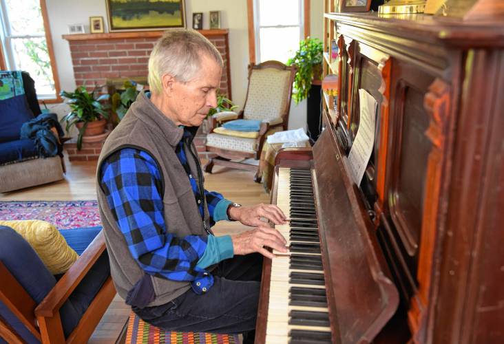 Randy Kehler, pictured playing piano in his Shelburne Falls home in 2021, died on Sunday. He was 80 years old.