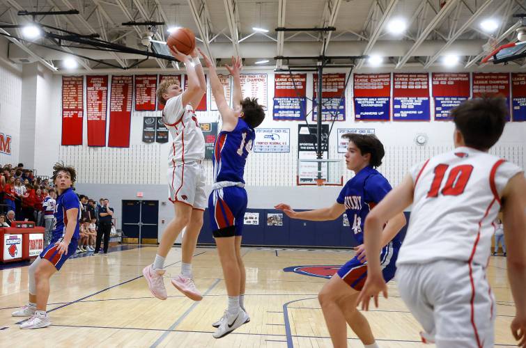 Frontier’s Garrett Dredge (11) puts up a jumper over Drury defender Brayden Durant (14) in the second quarter Friday night at Goodnow Gymnasium in South Deerfield.