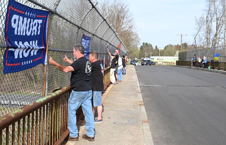 Scott Myers and Don Vollinger, both of Hatfield, support President Donald Trump as others protest the president on the Mountain Road Bridge over Interstate 91 in Hatfield, just south of the Whately town line, on Tuesday afternoon.