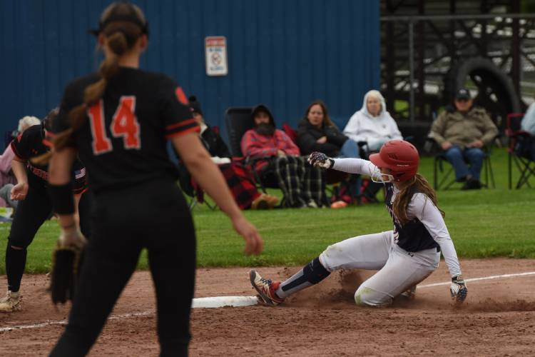 Frontier’s Skyler Steele (10) slides safely into third base during the Redhawks’ game with South Hadley on Monday afternoon in South Deerfield.