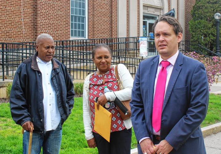 Attorney Ira Gant, right, thanks members of the Boston College Innocence Program outside of the Post Office on Main Street for their help in getting Elvio J. Marrero, left, a new trial. Marrero has been in prison for a 1994 murder but the state Supreme Judicial Court on Jan. 11 ordered a new trial. Joined by his sister, middle, Marrero briefly strolled around downtown Greenfield on Tuesday to test out his GPS monitoring device after posting $5,000 bail in Franklin County Superior Court.