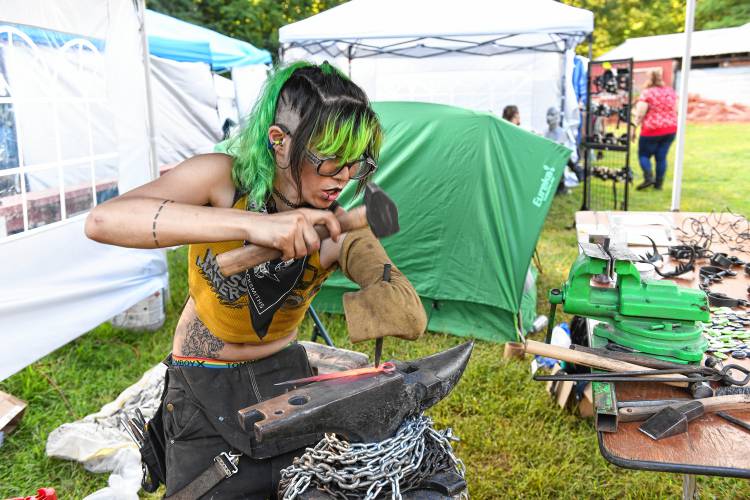 Scraps Sparcs puts their mark on a hair pin they forged at the RPM Fest at the Miller Falls Rod and Gun Club in Montague on Friday evening. 