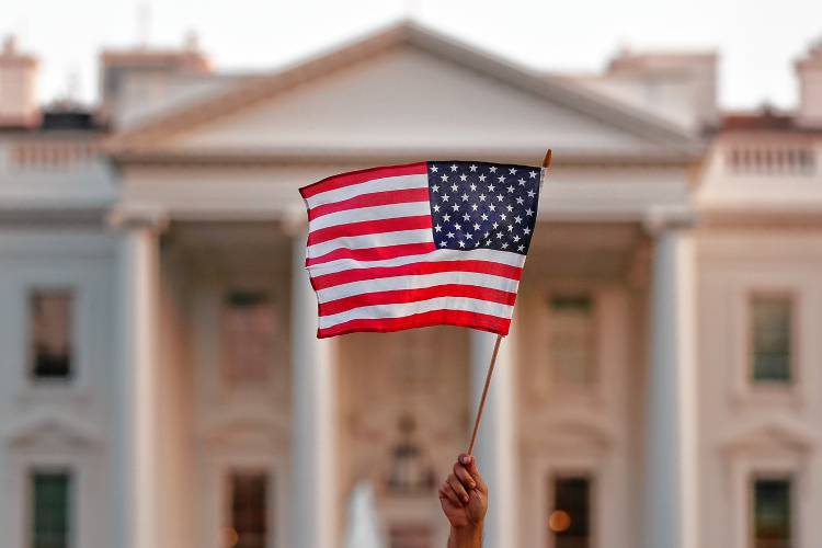 A flag is waved outside the White House in Washington, D.C. A flag is waved outside the White House in Washington, D.C.