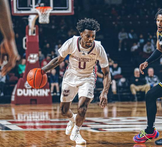 UMass guard Jaylen Curry (0) drives past a La Salle defender during the Minutemen’s 82-60 win over the Explorers on Sunday night at Mullins Center in Amherst.