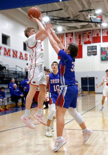 Frontier’s Garrett Dredge (11) attempts a shot before being fouled by Drury defender Connor Hinkell (32) in the second quarter Friday night at Goodnow Gymnasium in South Deerfield.
