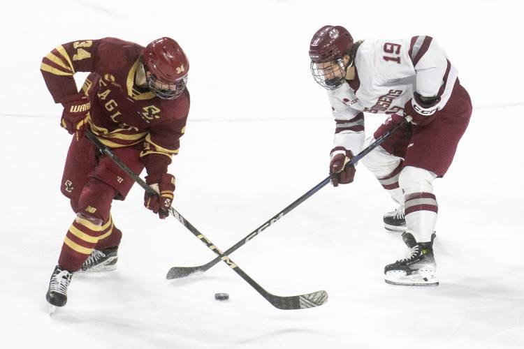 Boston College forward Gabe Perreault (34) and UMass right wing Cole O'Hara (19) compete for the puck during the college hockey game at the Mullins Center, Saturday, Feb. 15, 2025, in Amherst.