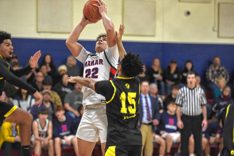 Mahar's Jayden Delgado goes up for a layup while defended by Boston United's Demarco Carter during an MIAA Div. 5 Round of 32 contest in Orange on Friday. 