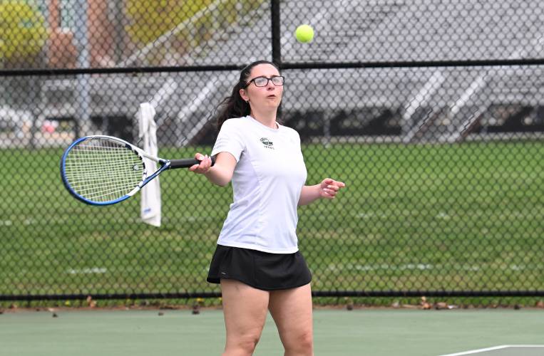 Greenfield’s Izzy Semomelli returns a volley against Mohawk Trail’s Anneke Whitsett at the Davis Street Courts in Greenfield Friday.