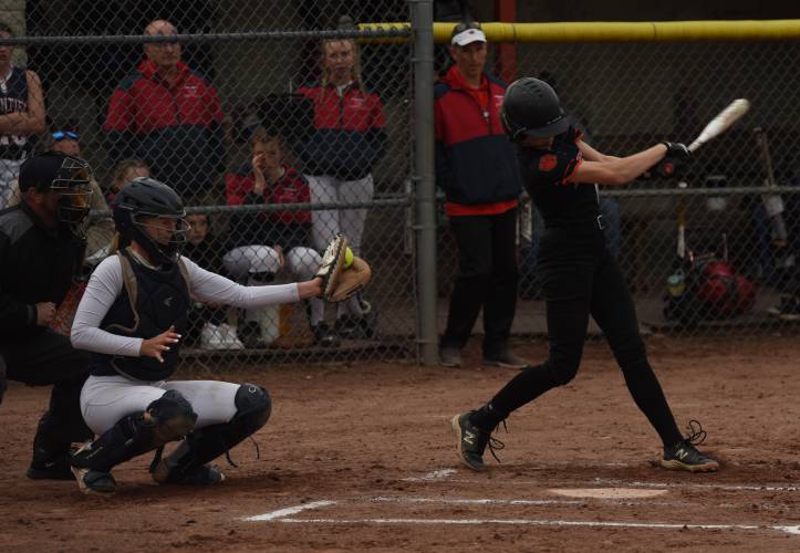 Frontier’s Delaney Fifield, left, catches the ball after South Hadley’s Ryley McMahon swung and missed during the Redhawks’ game against the Tigers on Monday afternoon in South Deerfield.