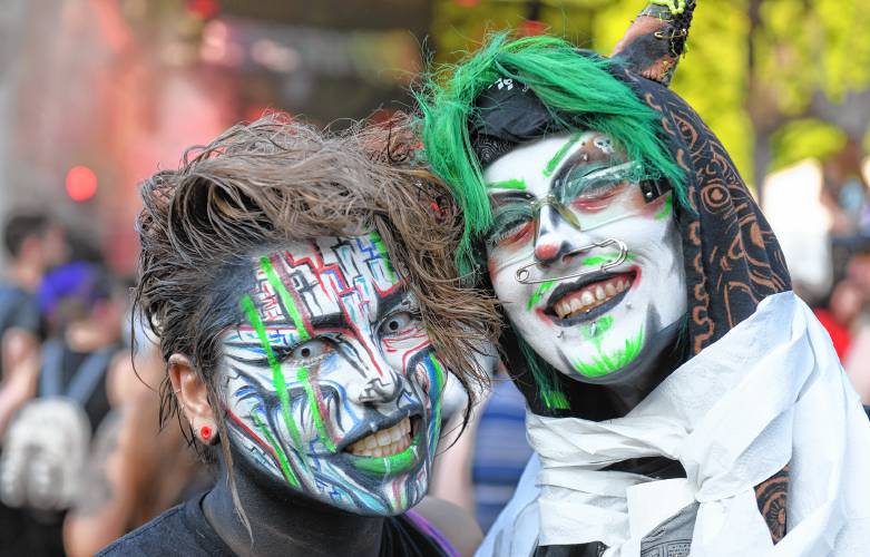 Paxx Headroom and Dexx Delerium, who were performing the Burlesque and Drag Show later, enjoy one of the bands.