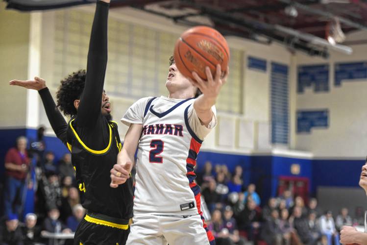 Mahar's Morgan Softic adjusts in air to make a layup against Boston International during an MIAA Div. 5 Round of 32 contest in Orange on Friday. 