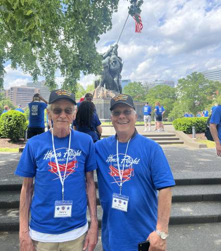 Denny Dwyer, left, and William Phelps, both of Greenfield, stand together in front of the Iwo Jima Memorial at the Marine Corps War Memorial in Washington D.C. during their Honor Flight trip on Saturday, May 3.