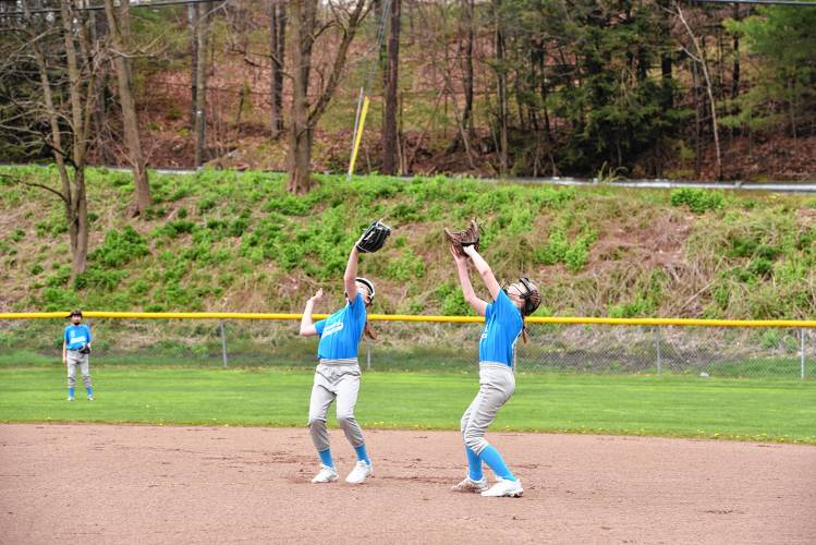 Descavich Plumbing second baseman Clara Stevens (left) and first baseman Charlie Lovett (right) go for a pop fly at Murphy Park on Saturday. 