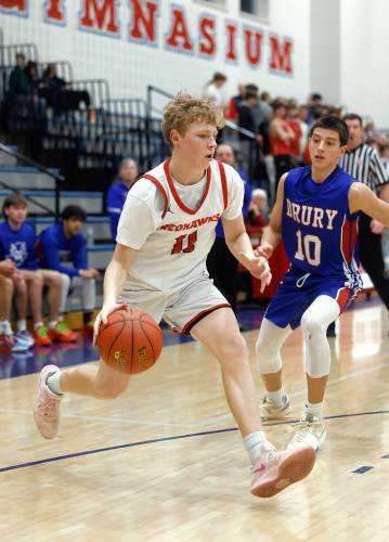 Frontier’s Garrett Dredge (11) drives the ball past Drury defender Jorge Bond (10) in the second quarter Friday night at Goodnow Gymnasium in South Deerfield.