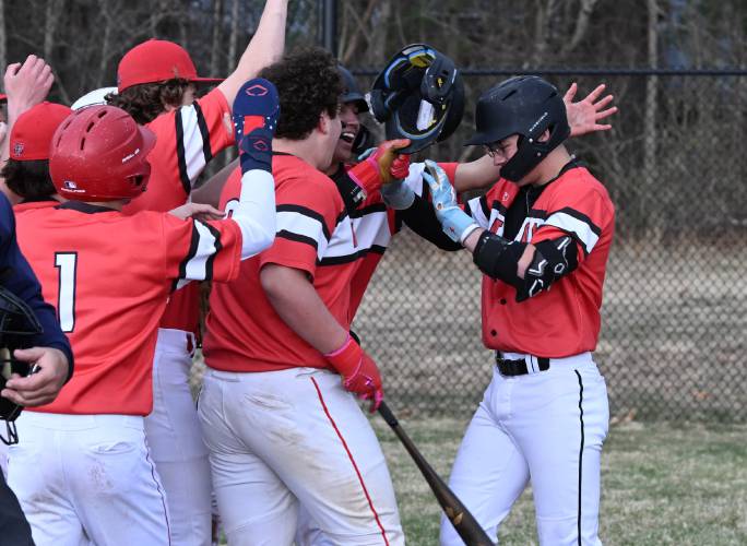 Athol’s Logan Cormier, right, is greeted at home plate by teammates after a home run earlier this season. Athol’s Logan Cormier, right, is greeted at home plate by teammates after a home run earlier this season.