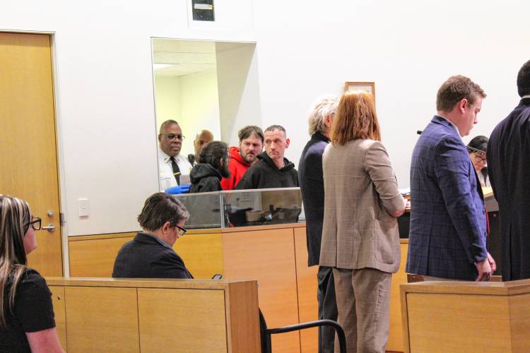Defendants Casey Guillemette, Michael Burek and Bradley Trombley, behind glass, charged with armed assault and home invasion, stand before Greenfield District Court Judge William Mazanec III at their arraignment Friday afternoon. Defendants Casey Guillemette, Michael Burek and Bradley Trombley, behind glass, charged with armed assault and home invasion, stand before Greenfield District Court Judge William Mazanec III at their arraignment Friday afternoon.