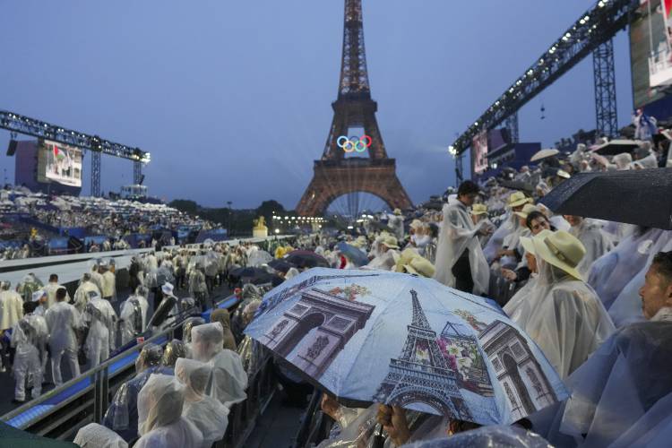 Spectators watch the opening ceremony of the 2024 Summer Olympics in Paris, France, Friday, July 26, 2024. (AP Photo/Thibault Camus)