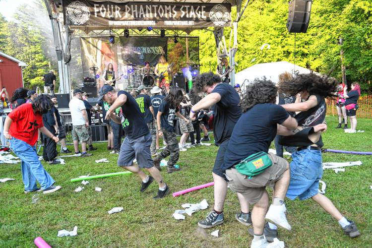 People dance and collide in the mosh pit.