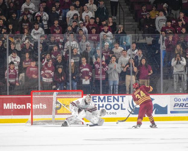 UMass goalie Michael Hrabal (30) blocks a penalty shot by Boston College forward Gabe Perreault (34) during the college hockey game at the Mullins Center, Saturday, Feb. 15, 2025, in Amherst. The penalty was called on UMass defenseman Larry Keenan, not pictured, for slashing.