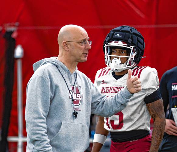 UMass offensive coordinator Mike Bajakian instructs his players through a drill during the Minutemen’s spring practice at The Bubble in Amherst earlier this week.
