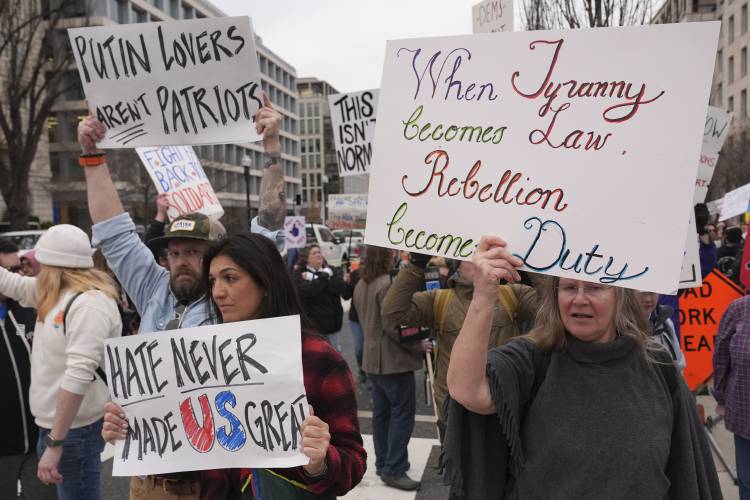 Demonstrators protest against the Trump administration near the White House on March 14 in Washington.