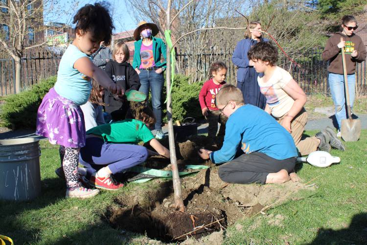 Children help plant one of two linden trees at Energy Park in Greenfield after the Interfaith Council of Franklin County’s inaugural Earth Day celebration in 2022. The celebration returns Monday, April 21, from noon to 3 p.m.