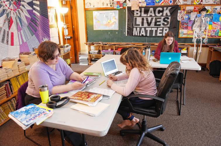 Math tutor Alethea Tschetterwood works with Lily Thorp, 11, at Four Winds School in Gill on Thursday. School Director Hattie Adastra is seated to the right.