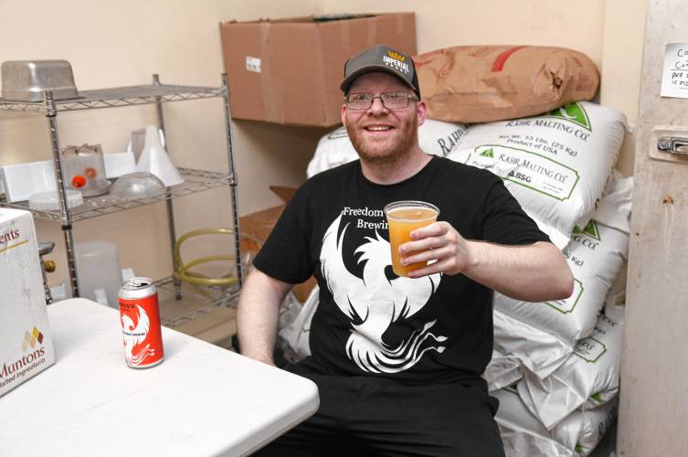 Freedom Street Brewery owner Errin Woessner enjoys the fruits of his labor at his brewery in Erving.