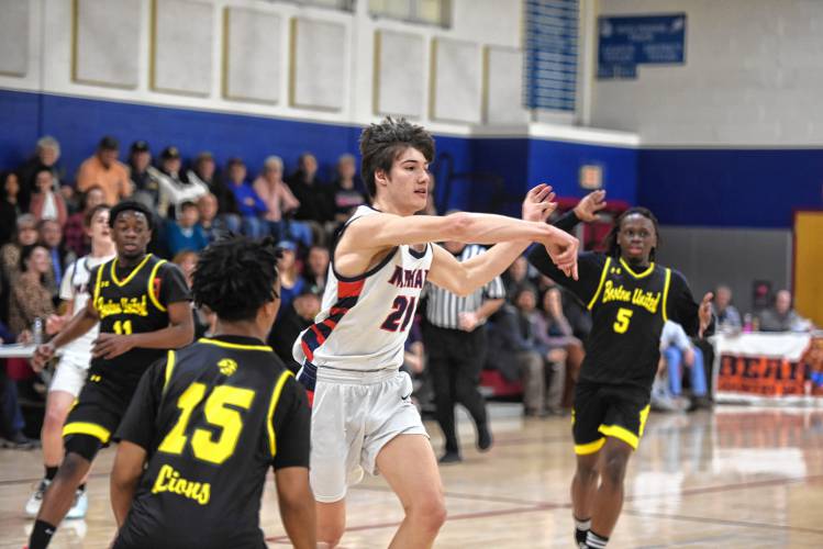 Mahar's Marshall Ames tosses a pass out to the perimeter against Boston International during an MIAA Div. 5 Round of 32 contest in Orange on Friday. 